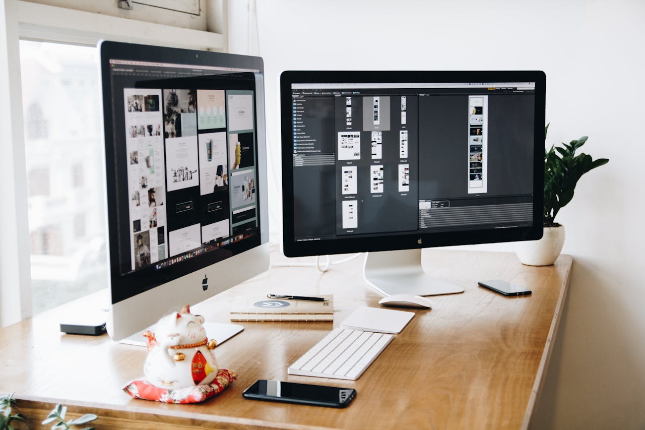 The Art of Drawing Readers In: Your attractive post title goes here A well-organized design workspace with dual monitors and design software on display.